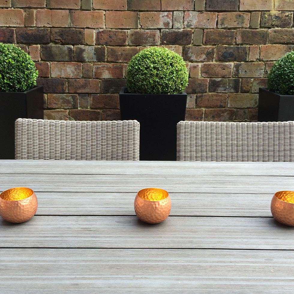 Copper tea lights from dining area of Southampton town garden